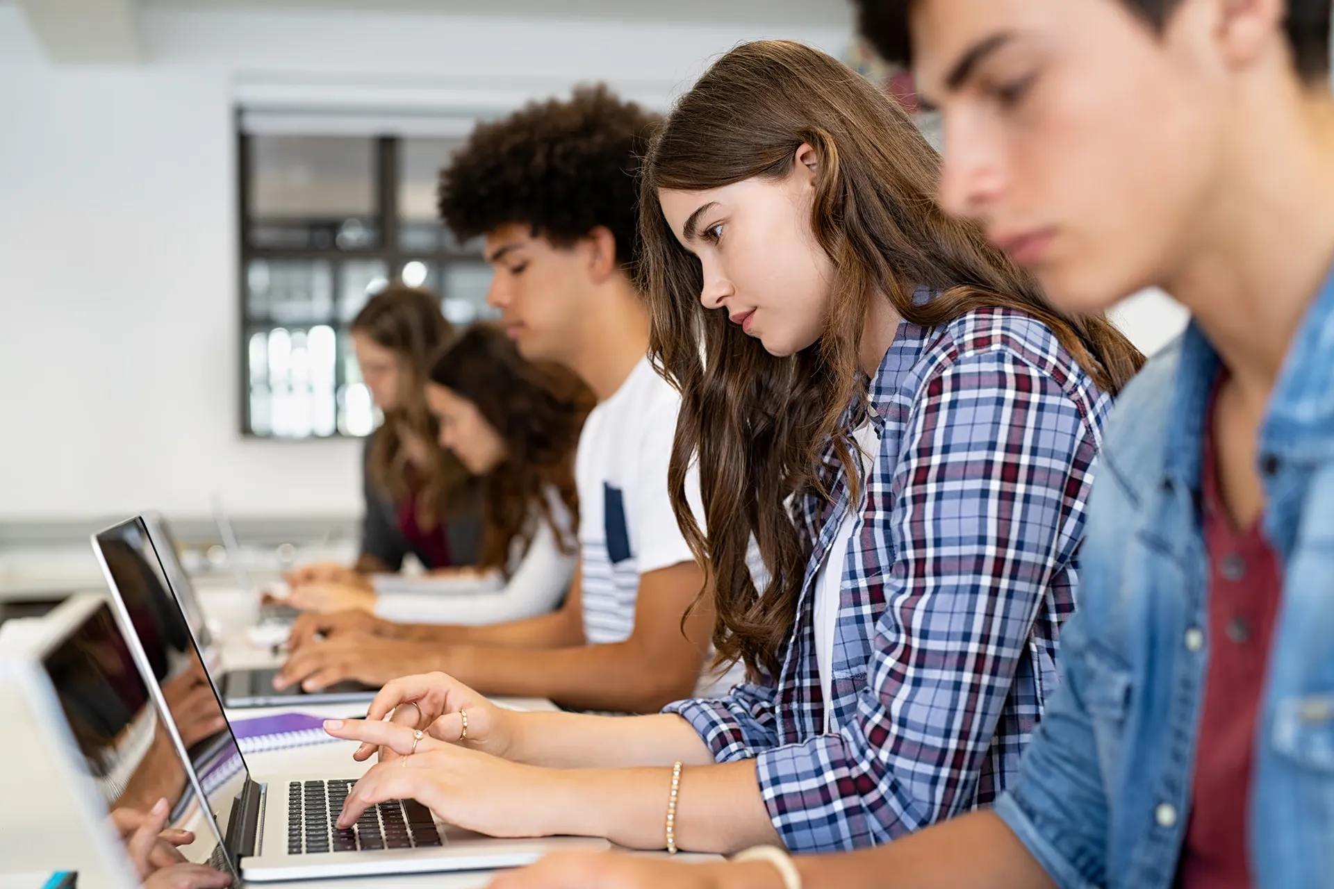 Students working on laptops in a classroom